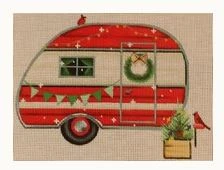 A red and white camper with christmas decorations.