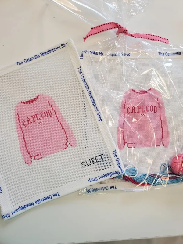 A pair of pink shirts are in plastic bags.