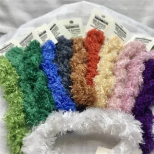 A bunch of different colored yarn sitting on top of a table.