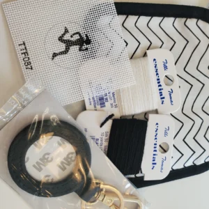 A black and white bag with some items on it
