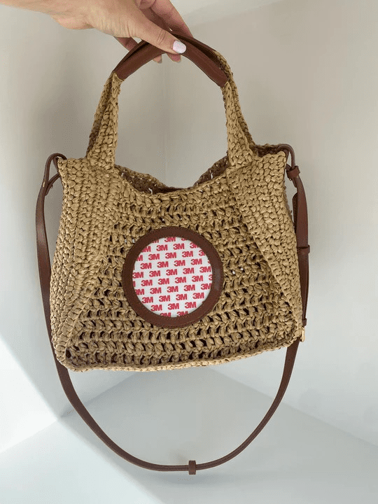 A crocheted bag with a red and white pattern on the front.