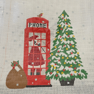 A red phone booth with christmas tree and santa clause.