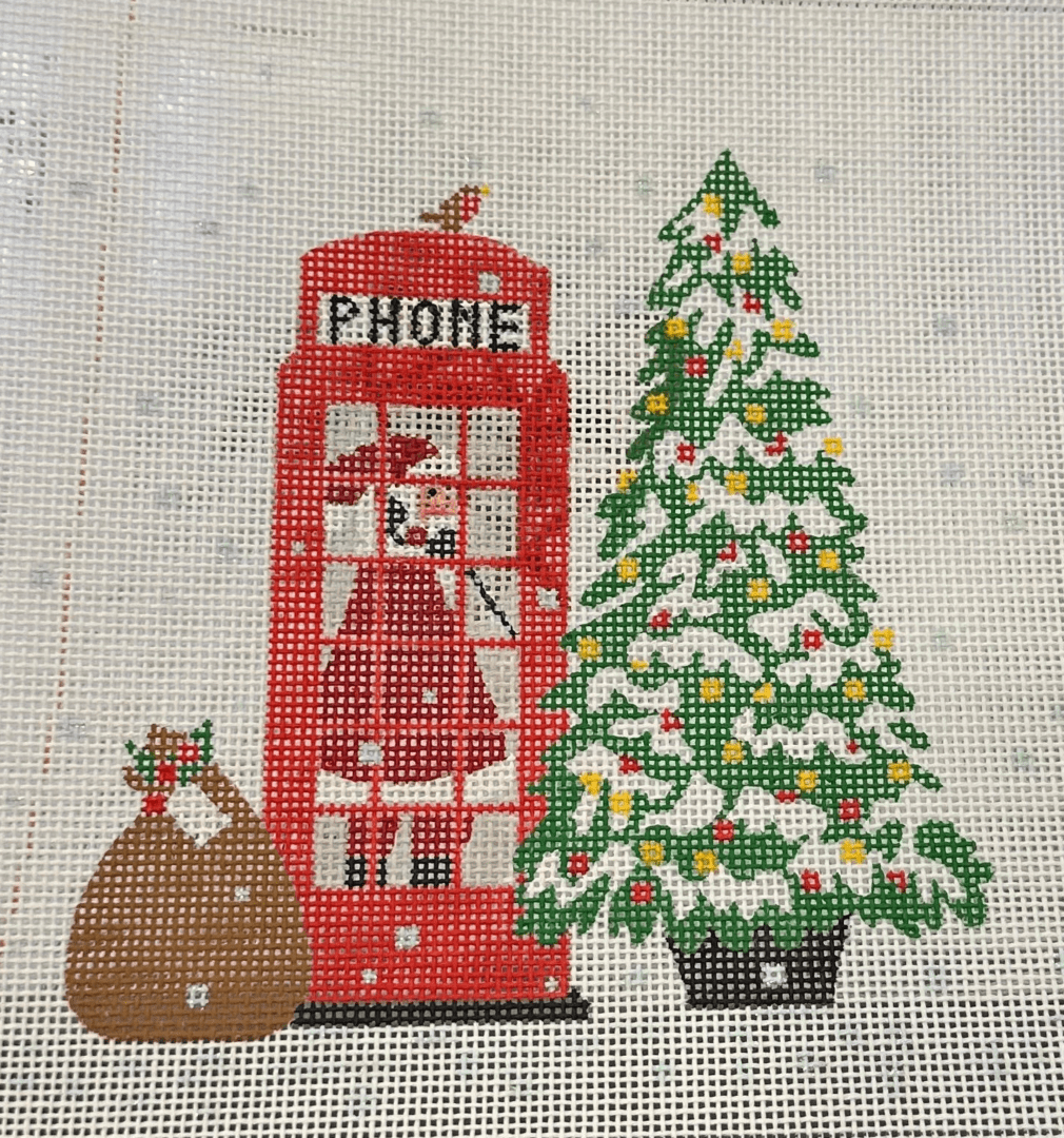 A red phone booth with christmas tree and santa clause.