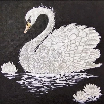 A swan is sitting on the water with its wings spread.