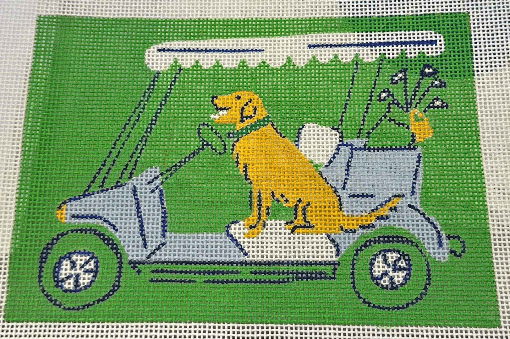 A dog in the back of a green car.