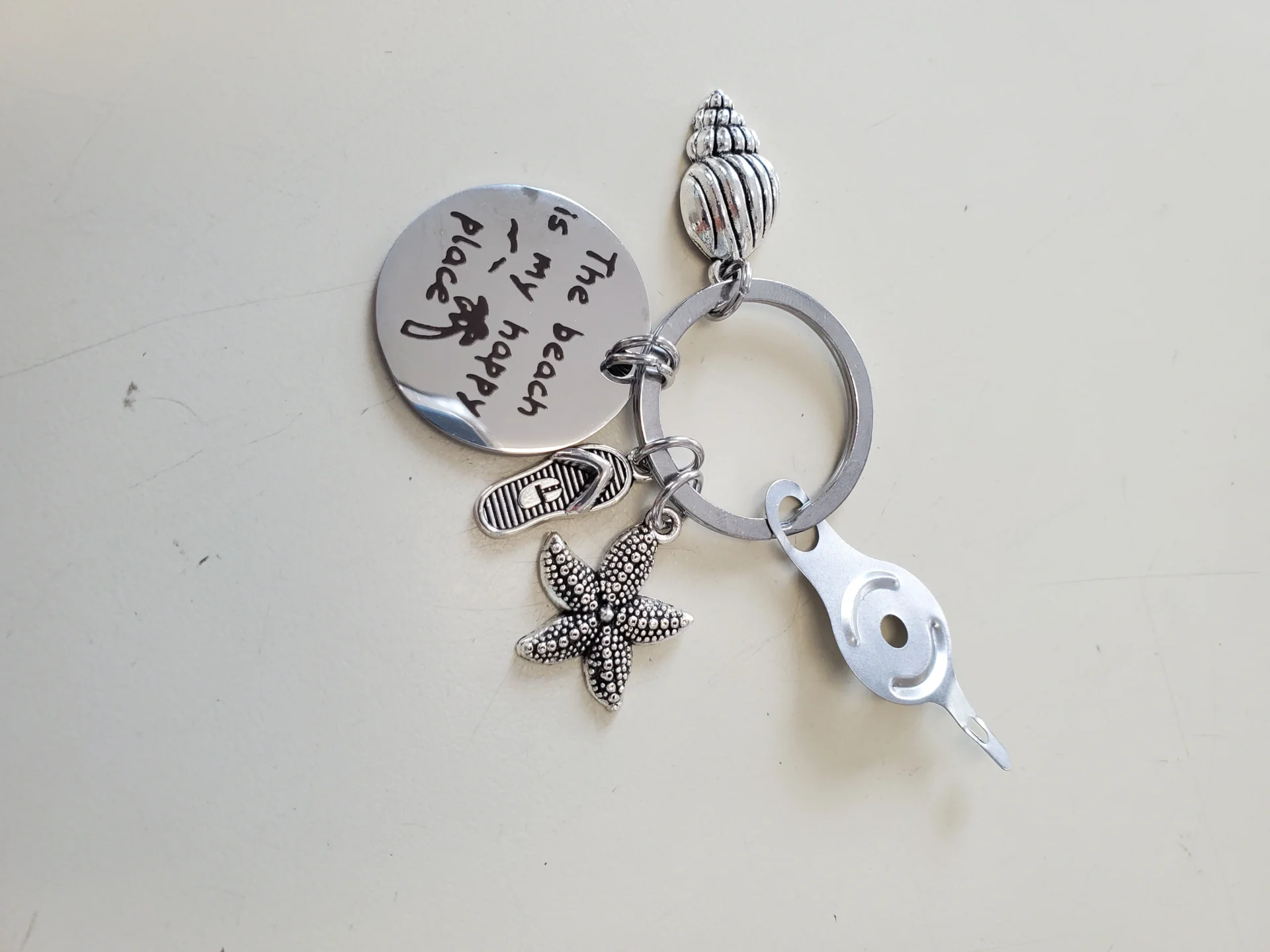 A key chain with shells and starfish on it.