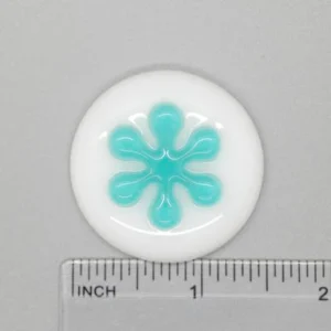 A white button with blue design on it.