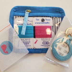 A blue purse with some little bags and a key chain