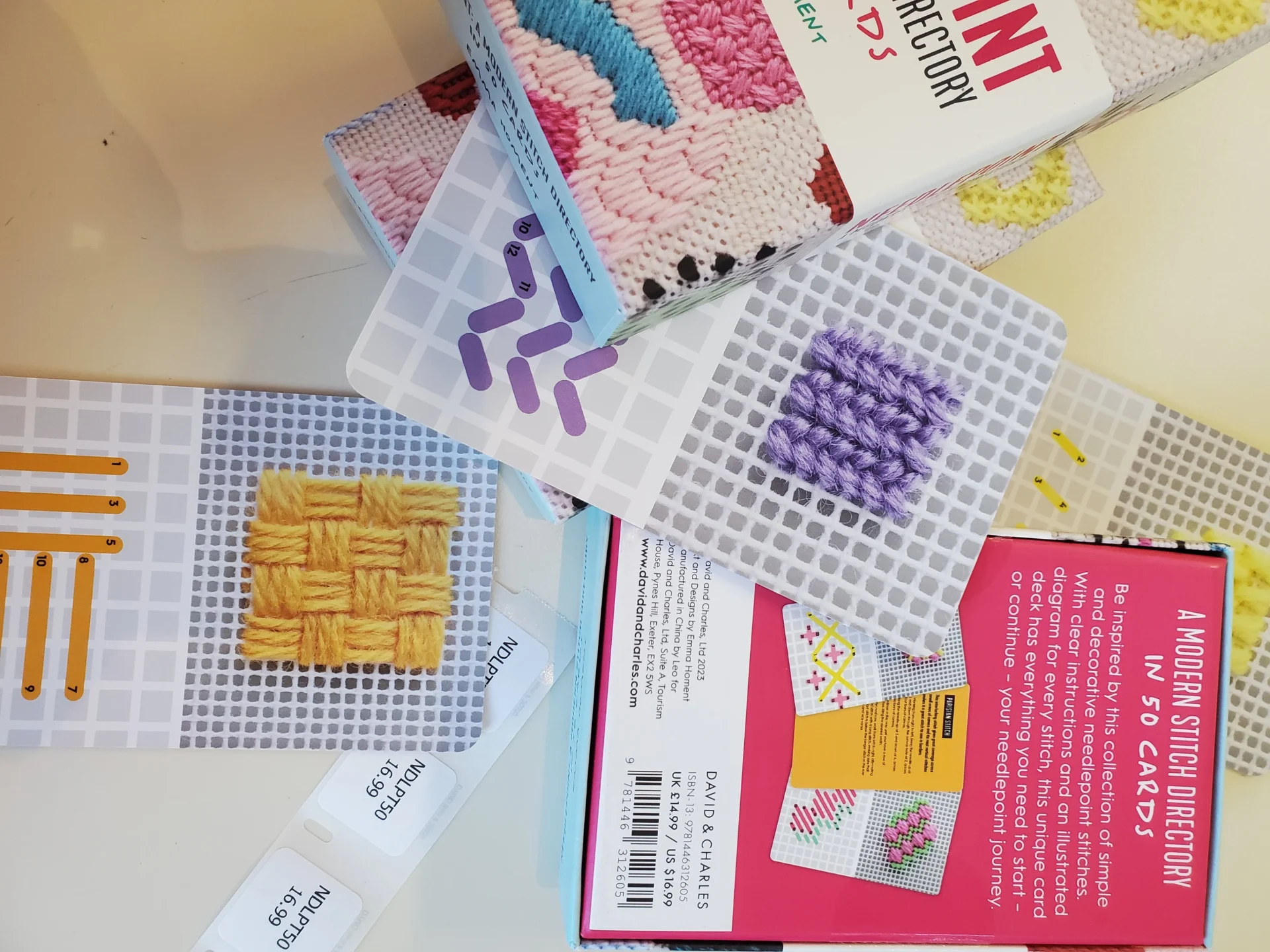 A table with several books and some plastic beads.