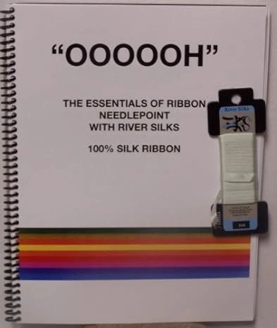 A book with a ribbon and a picture of a rainbow.