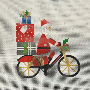 A santa clause riding a bike with presents on the back.