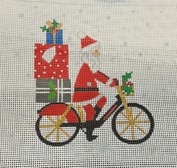 A santa clause riding a bike with presents on the back.