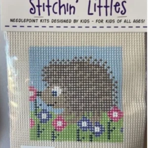 A cross stitch kit of a hedgehog with flowers.