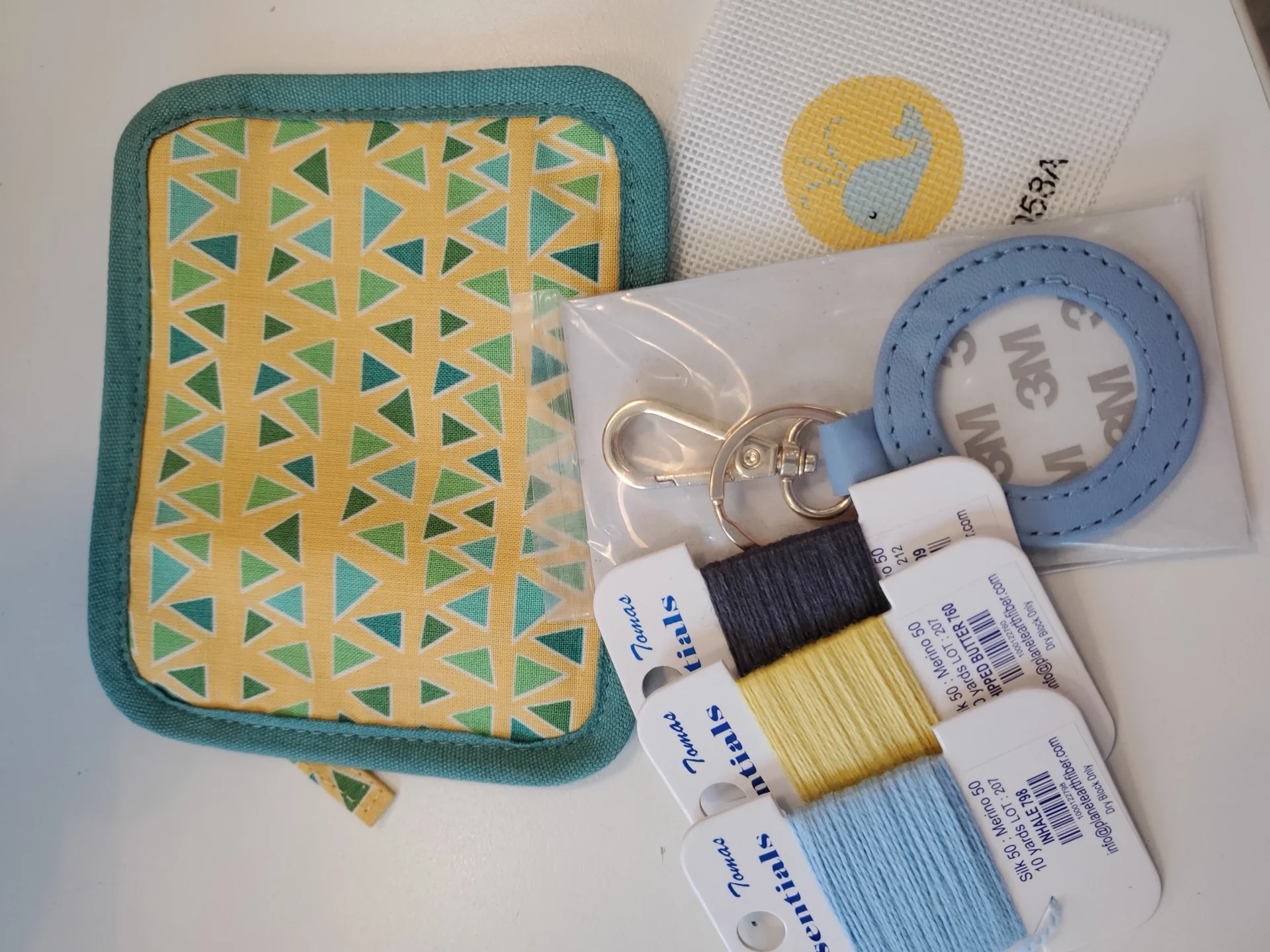 A small bag with some sewing supplies on it