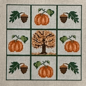 A square of nine squares with an autumn tree and pumpkins.