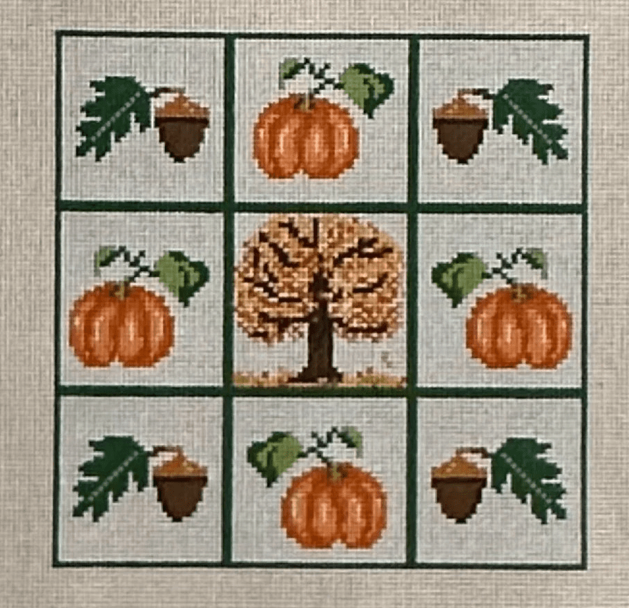 A square of nine squares with an autumn tree and pumpkins.