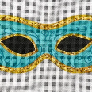 A blue mask with gold trim on linen.