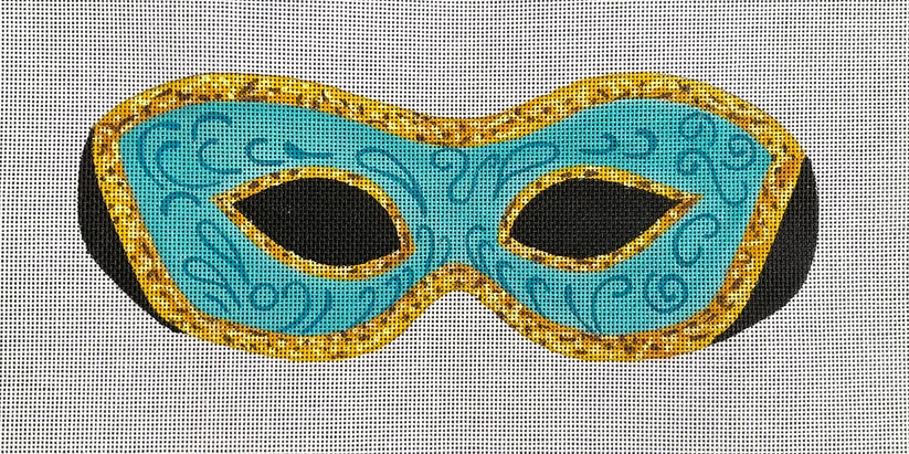 A blue mask with gold trim on linen.