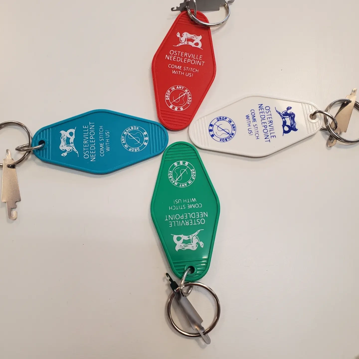 A group of four key chains that are sitting on top of a table.