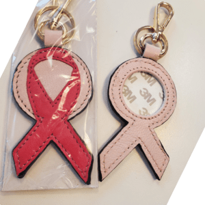 A red ribbon and pink ribbon key chain.