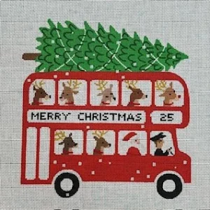 A red double decker bus with christmas decorations on top.