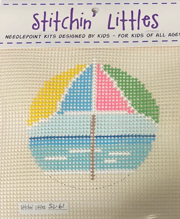 A cross stitch kit of a sailboat with the name stitchin ' littles.