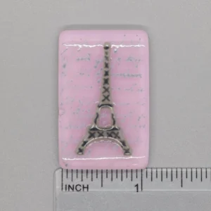 A pink piece of paper with a picture of the eiffel tower.