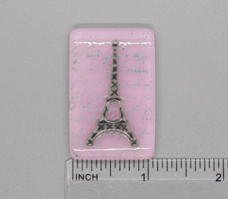 A pink piece of paper with a picture of the eiffel tower.