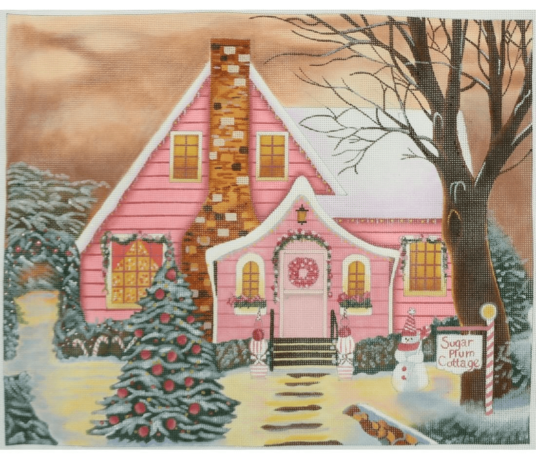 A pink house with a christmas tree in the front yard.