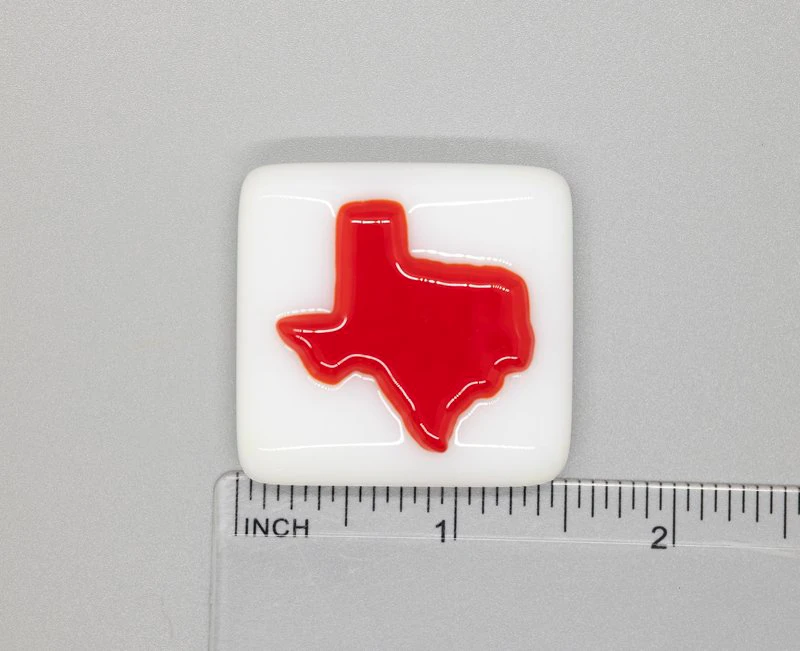 A red and white square with the state of texas on it.