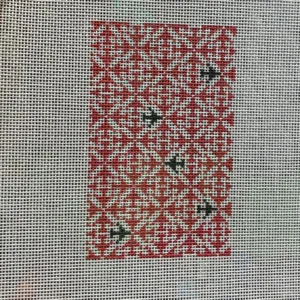 A red and white pattern on the fabric.