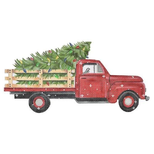 A red truck carrying christmas trees in the back.