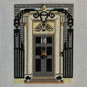 Cross-stitched ornate black door with columns
