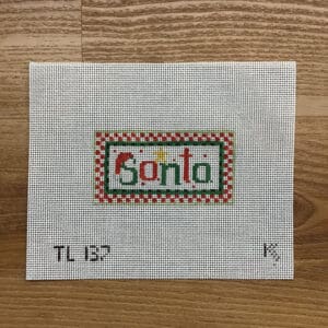 Cross-stitched Santa on needlepoint canvas