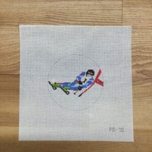 Cross-stitch canvas with colorful airplane embroidery