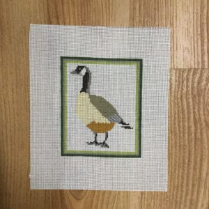 Cross-stitched Canada goose in green frame